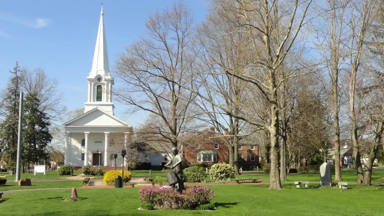 The Bloomfield town green with its white 1858 meetinghouse church and central war monument in Bloomfield, Connecticut